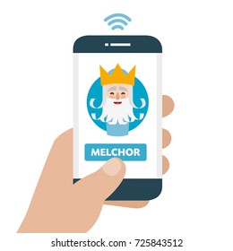 Christmas is here. Send your letter to The three wise men of orient from your cell phone. Hand holding smartphone. Melchior written in spanish