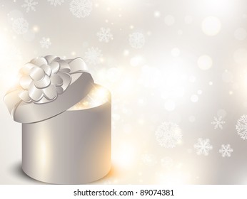 Christmas holiday background with opened gift box over snowflakes