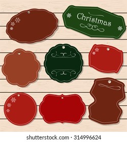 Christmas holiday set - labels, tags and decorative graphic elements. Vintage collection for Xmas. Elements on a light wooden texture. Merry Christmas and Happy New Year!