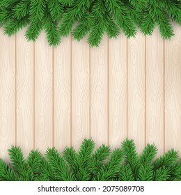 Christmas holidays. Pine branches on wooden texture background
