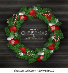 Christmas holidays. Christmas wreath on black wooden texture background.
