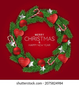 Christmas holidays. Christmas wreath on red background.
