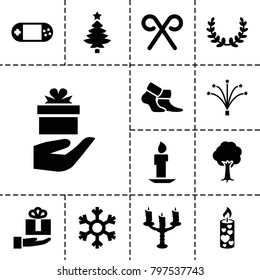Christmas icons. set of 13 editable filled christmas icons such as tree, candle, gift on hand, portable console, candy cane, fireworks, candlestick, snowflake, olive wreath