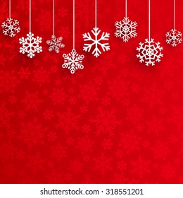 Christmas illustration with several hanging snowflakes on red background