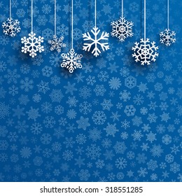 Christmas illustration with several hanging snowflakes on blue background