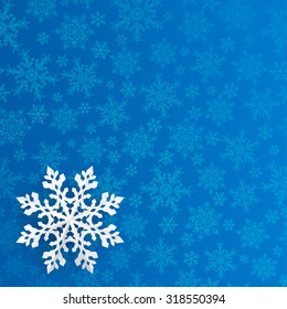 Christmas Illustration With Snowflake Cut Out Of Paper On Blue Background Of Small Snowflakes