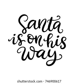Christmas ink hand lettering. Santa is on his way phrase. Greeting card with brush calligraphy, isolated on white background. Vector illustration.