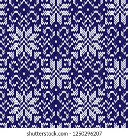 Christmas jacquard  seamless pattern.  Knitted white and blue winter background with snowflakes. Vector illustration.