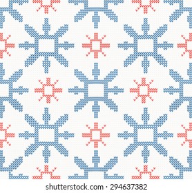 Christmas knitted seamless pattern with blue and red snowflakes on a white background. Christmas concept for banner, placard, billboard or web site. New Year retro greeting card. Image for invitation