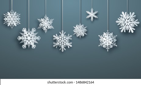 Christmas large complex paper hanging snowflakes on gray background