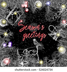 Christmas lettering and calligraphy design. Season's Greetings handwritten phrase in Xmas wreath frame. Modern holiday hand writing font. Hand drawn holiday design elements for greeting card. Vector. 