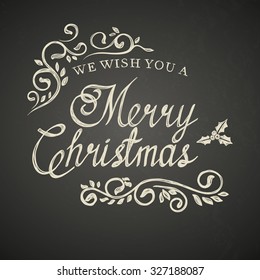 Christmas lettering with decorative elements on black board