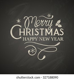 Christmas lettering with decorative elements on black board