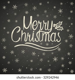 Christmas lettering with decorative elements on black board