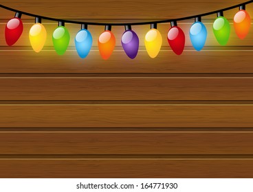 Christmas light bulbs on wooden background