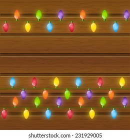 Christmas light bulbs on wooden background