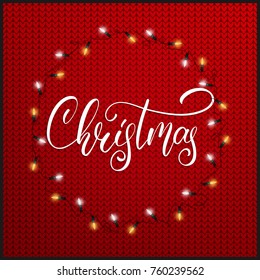 Christmas. Christmas lights and holiday script lettering on knitted background