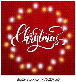 Christmas. Christmas lights and holiday script lettering on knitted background