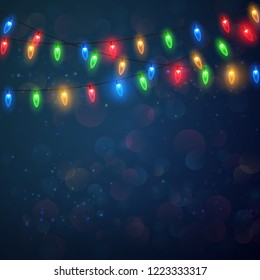 Christmas lights isolated on blue background. Colorful bright Xmas garland. Vector red, yellow, blue and green glow light bulbs on wire strings. Festive vector template