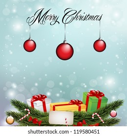 Christmas lights on blue background and Christmas tree branches, ornaments presents and decor.