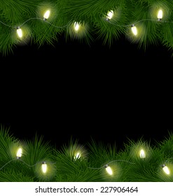 Christmas Lights On Pine Branches Isolated On Black Background