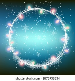Christmas lights in twist circle with space for text on winter background
