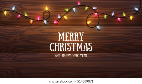 Christmas lights.new year background with colorful garland on wooden surface