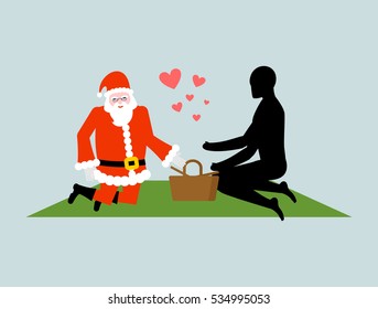 Christmas Lover. Santa Claus on picnic. Rendezvous in Park. Meal in nature. Plaid and basket for food on lawn. Romantic New Year date.
