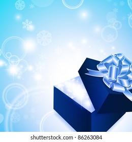 Christmas magic gift box with ribbon bow over bright winter background