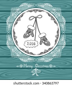 Christmas Mitten in circle  in Zen doodle  style with lace on blue wood background or creative Post Card or for decoration  of package, door in shop or for Christmas or New Year things