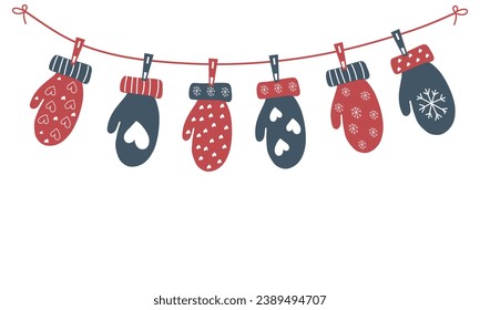 Christmas mittens are hanging on a rope. Garland of suspended mittens on a white background