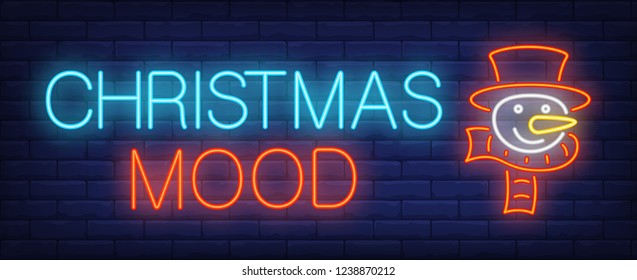 Christmas mood neon sign. Glowing inscription with snowman in cylinder hat and scarf on brick wall background. Can be used for christmas, winter, advertisement