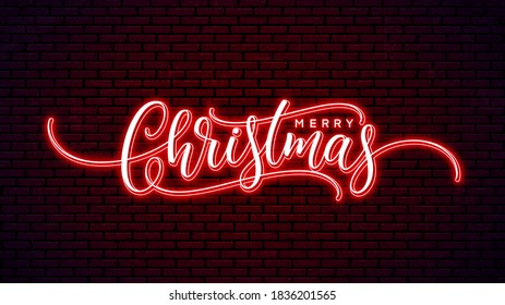 Christmas neon handwritten lettering isolated on wall background. Xmas glowing text design. Merry Christmas bright hand lettering. Holiday calligraphy.