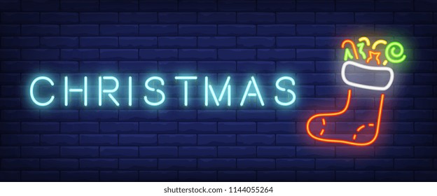 Christmas neon text and felt boot with presents. Christmas eve or New Year Day concept. Night bright neon sign, colorful billboard, light banner. Vector illustration in neon style.