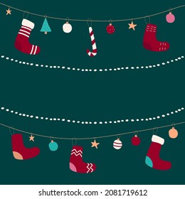 Christmas and New Year 2022 greeting card with garlands, socks and toys on green background.
