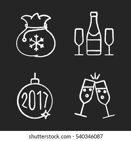 Christmas and New Year chalk icons set. Gift bag, toasting champagne glasses, bottle, 2017 Xmas tree ball. Isolated vector chalkboard illustrations