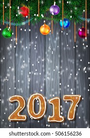 Christmas or New Year colorful greeting card with gingerbread number of 2017 with evergreen pine branch and baubles with tinsel. Decorated wood background. Vector illustration
