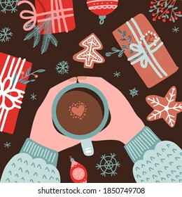 Christmas and New Year cozy composition with Human hands in sweater holding coffee mug surrounded by gifts, gingerbread, fir branches. Vector flat illustration top view.