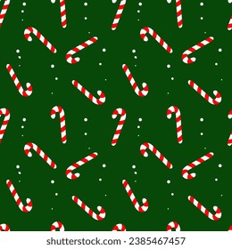 Christmas and New Year in flat style. Seamless texture of Christmas candies on a green background. Candy cane.