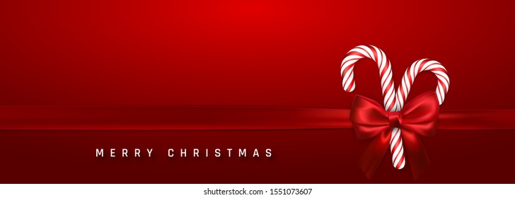 Christmas or New Year greeting card. Realistic candy cane with red bow and ribbon on red background. Vector illustration.