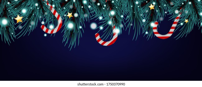 Christmas and New Year greeting card. Christmas fir tree branches with lollipop, bokeh and golden star. Holiday dark blue Background.