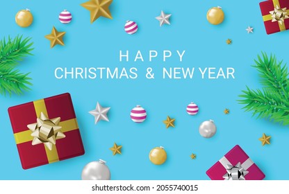Christmas and New Year Greeting Card with composition festive decorations, fir tree branch, decorations and gift box isolated on blue background