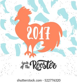 Christmas and New Year lettering calligraphy greeting card with 2017 year of the red fire rooster. Cock silhouette on the top of illustration.