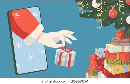 Christmas and New Year online e-commerce shopping and delivery. Winter holiday sale concept. Santa's hand from mobile phone puts Christmas gift box under Christmas tree 