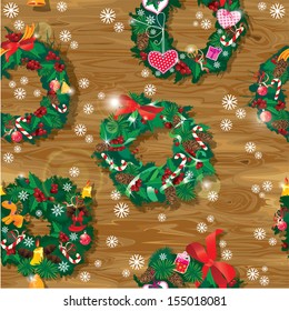 Christmas and New Year Seamless pattern with wreaths decorated horse toys, balls, bows, ribbons, sweets, candies and presents on wooden background.