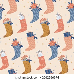 Christmas and New Year seamless pattern with festive socks filled with gifts. Vector flat hand drawn illustration