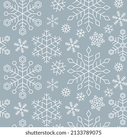 Christmas, New Year seamless pattern of white snowflakes on blue background. Snowflakes in different shapes and forms. Christmas and New Year background. Vector Illustration.