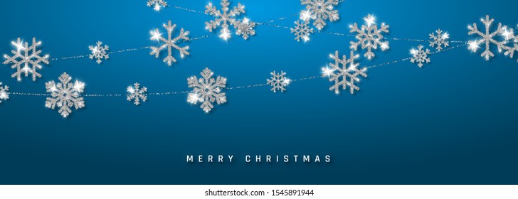 Christmas or New Year silver snowflake decoration garland on blue background. Hanging glitter snowflake. Vector illustration.