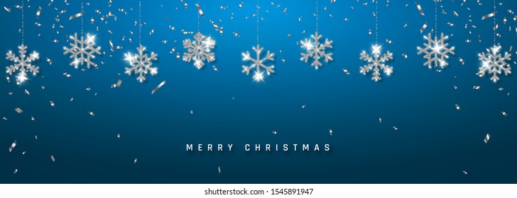 Christmas or New Year silver snowflake decoration garland with confetti on blue background. Hanging glitter snowflake. Vector illustration.