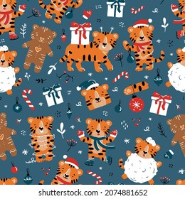 Christmas and New Year tigers vector seamless pattern with cute cartoon animals in Santa Claus costumes, gifts and toys on a blue background. Winter symbol of 2022 for wrapping paper or fabric.